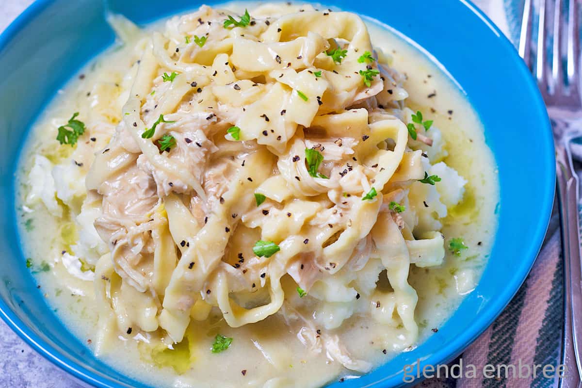 creamy chicken and noodles in blue bowl