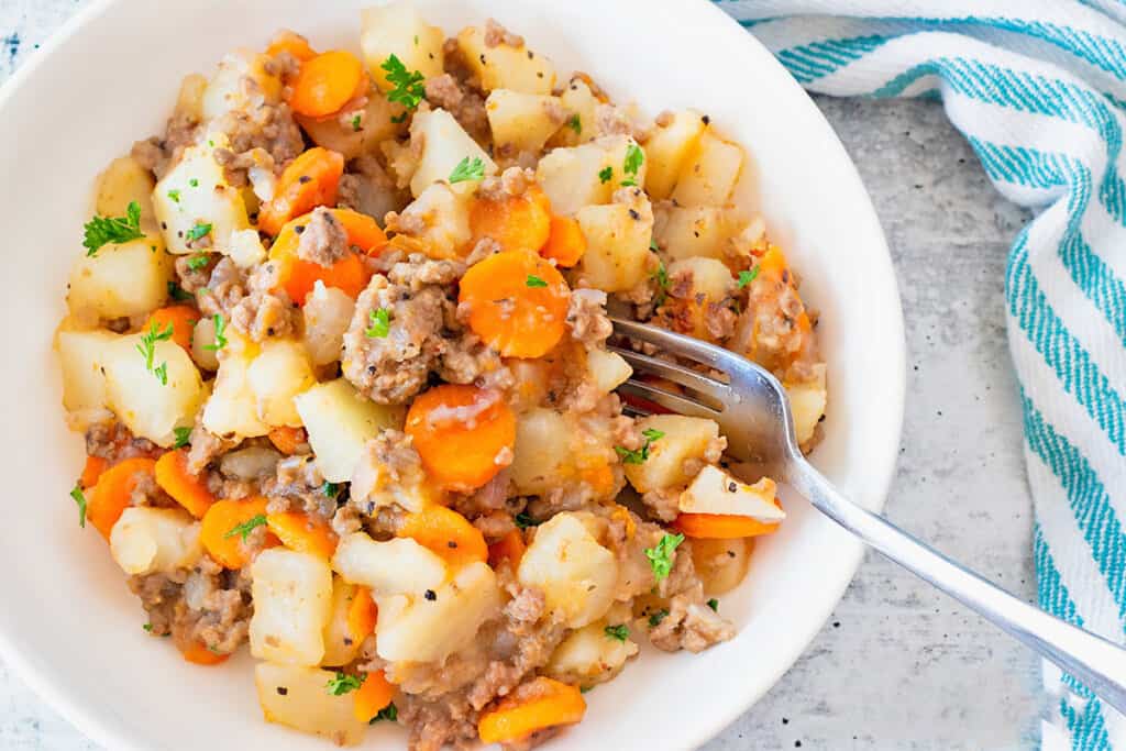 ground beef and potatoes on a white plate