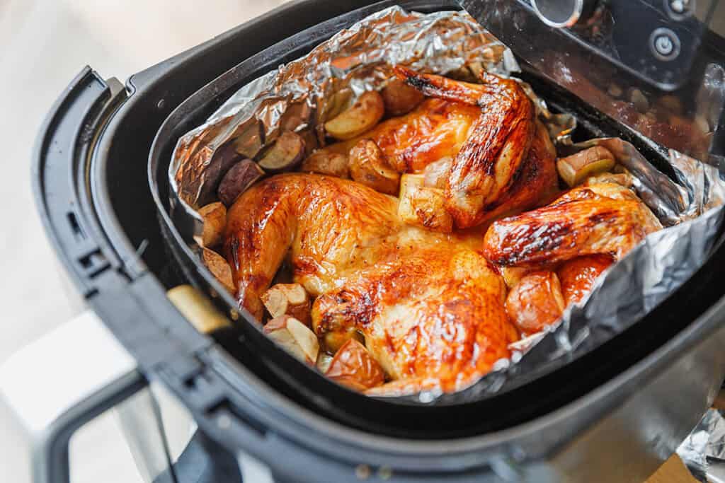 Roast Chicken in an air fryer with roasted potatoes