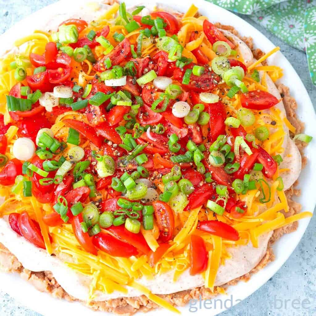 Taco dip on a white plate,