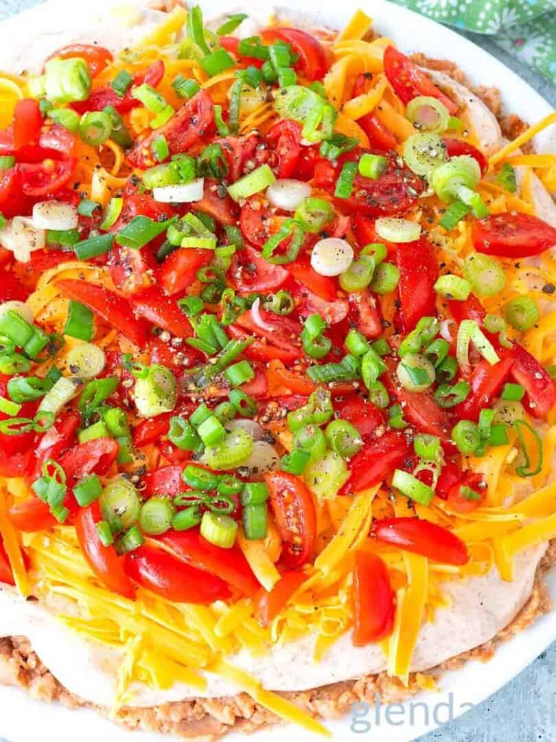 Taco dip on a white plate,