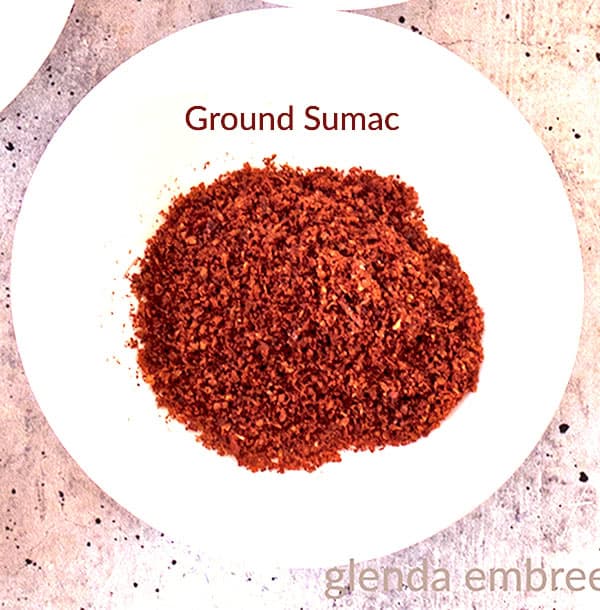 Ground sumac in a white bowl.