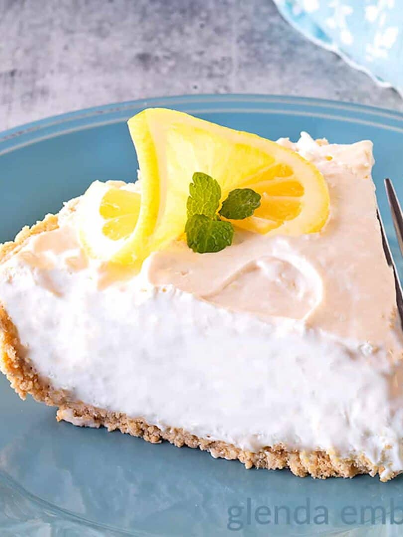 Cream cheese Lemonade Pie slice on a blue stoneware plate.