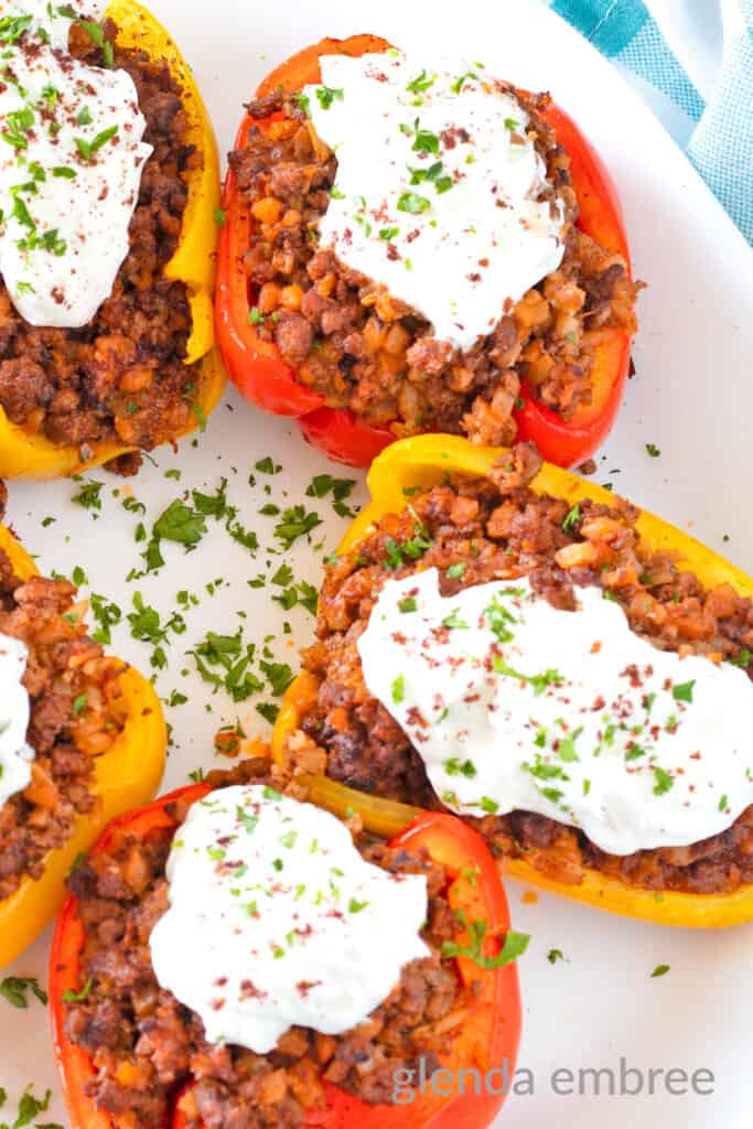 Air Fryer Stuffed Peppers with Curried Ground Lamb on a white plate.