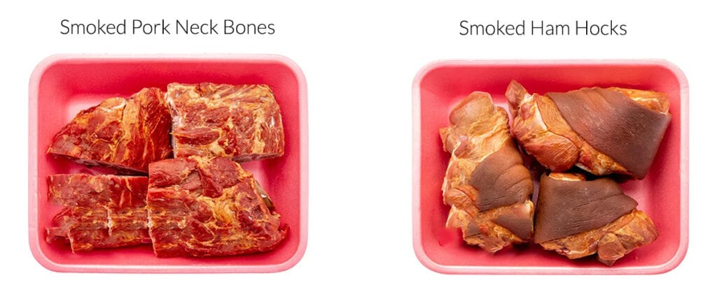 Smoked Neck Bones on a styrofoam tray next to ham hocks on a styrofoam tray.