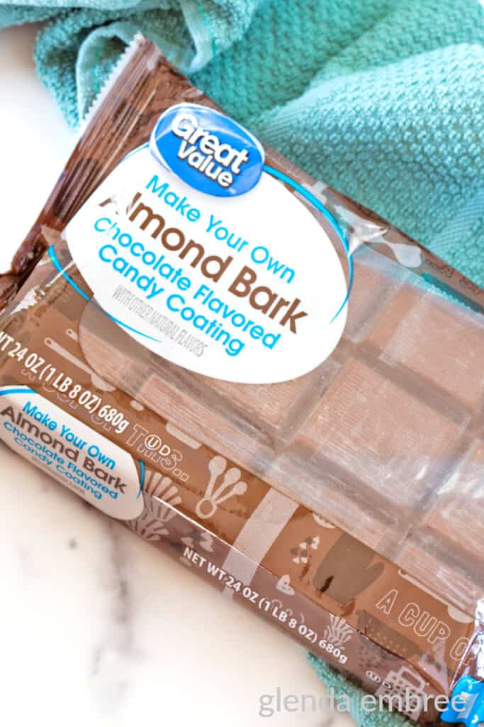 Chocolate almond bark in its commercial packaging on a white countertop.