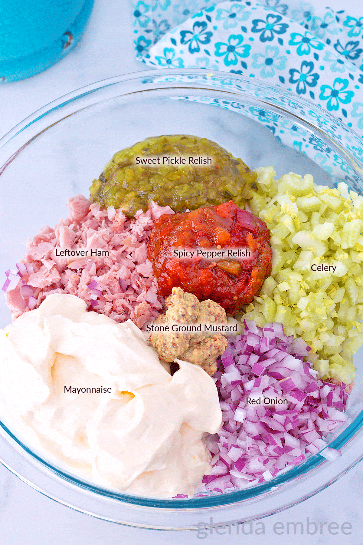 Ingredients for Old Fashioned Ham Salad (Deviled Ham) in a clear glass mixing bowl.  