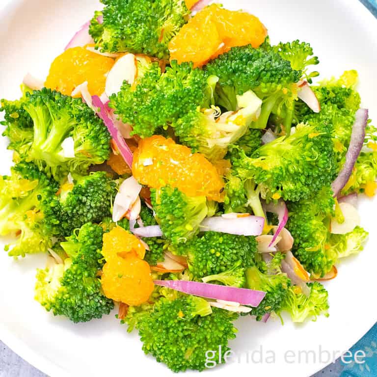 Crunchy Broccoli Salad with Mandarin Oranges on a white plate.