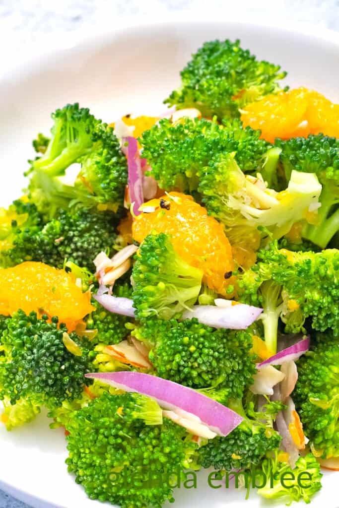 Crunchy Broccoli Salad with Mandarin Oranges on a white plate.
