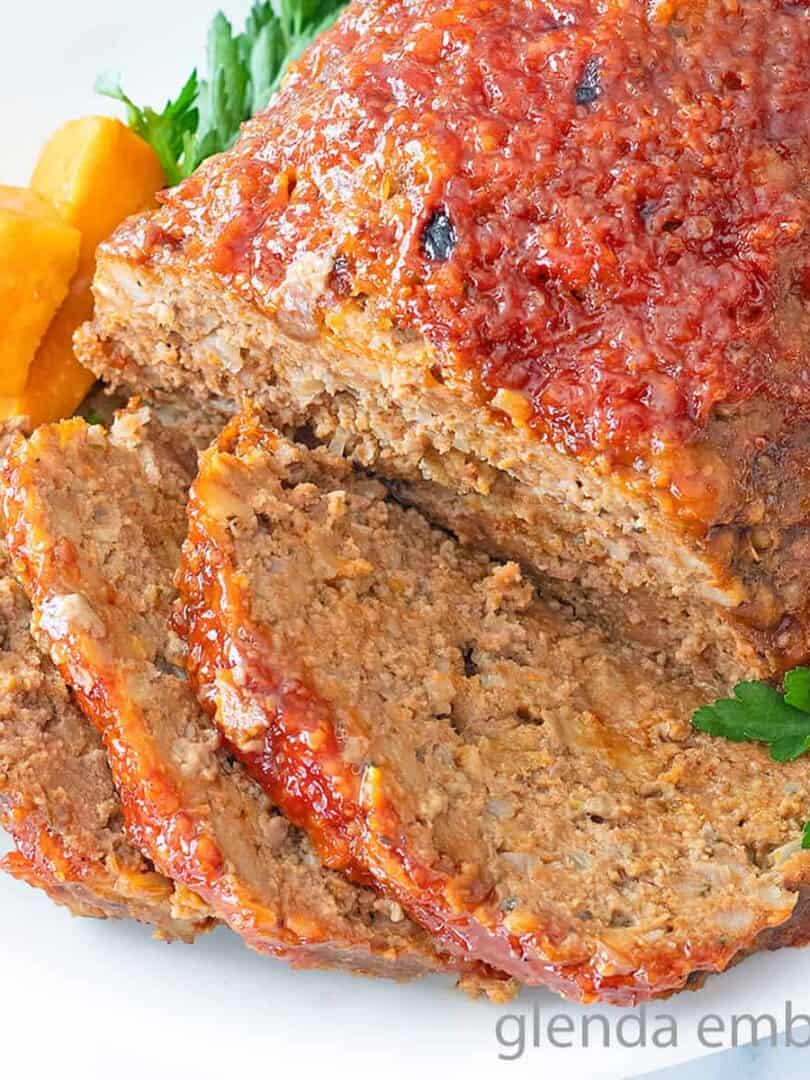 Stove Top Stuffing Meatloaf (Slow Cooker Meatloaf) served on a white platter with sweet potato chunks.