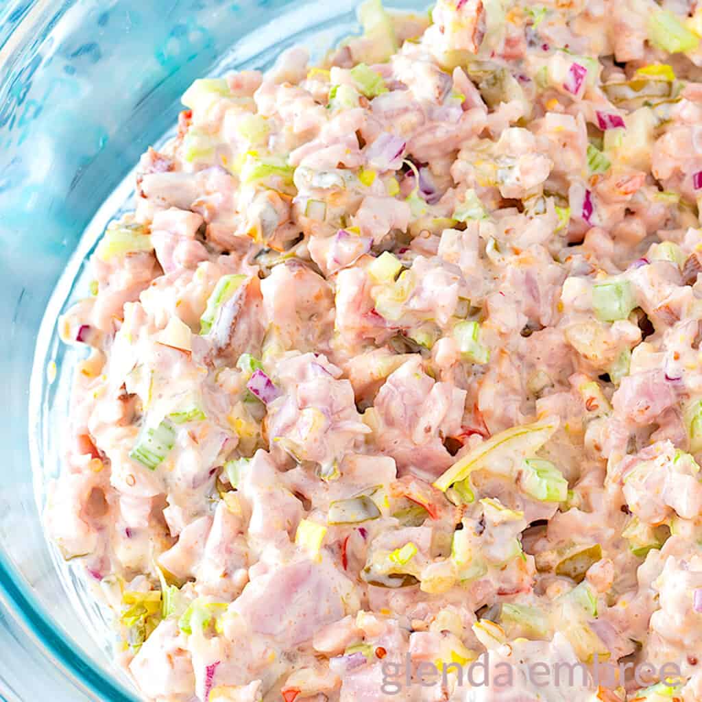 Old Fashioned ham Salad (Deviled Ham) in a clear glass mixing bowl .