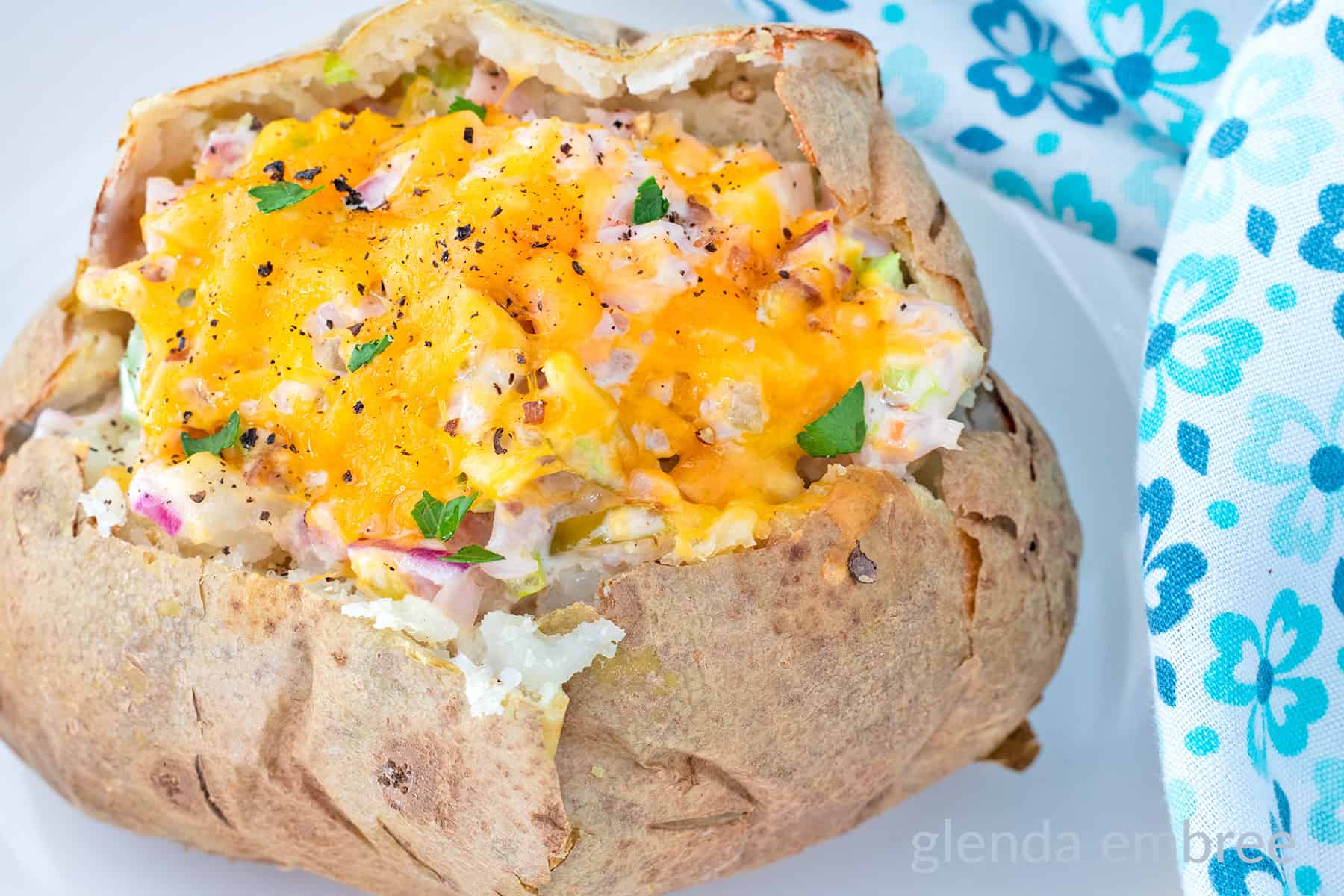 Baked Potato stuffed with Old Fashioned Ham salad and topped with melted cheddar cheese.