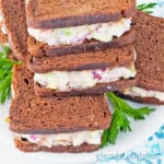 Mini ham salad sandwiches on pumpernickle rye squares.