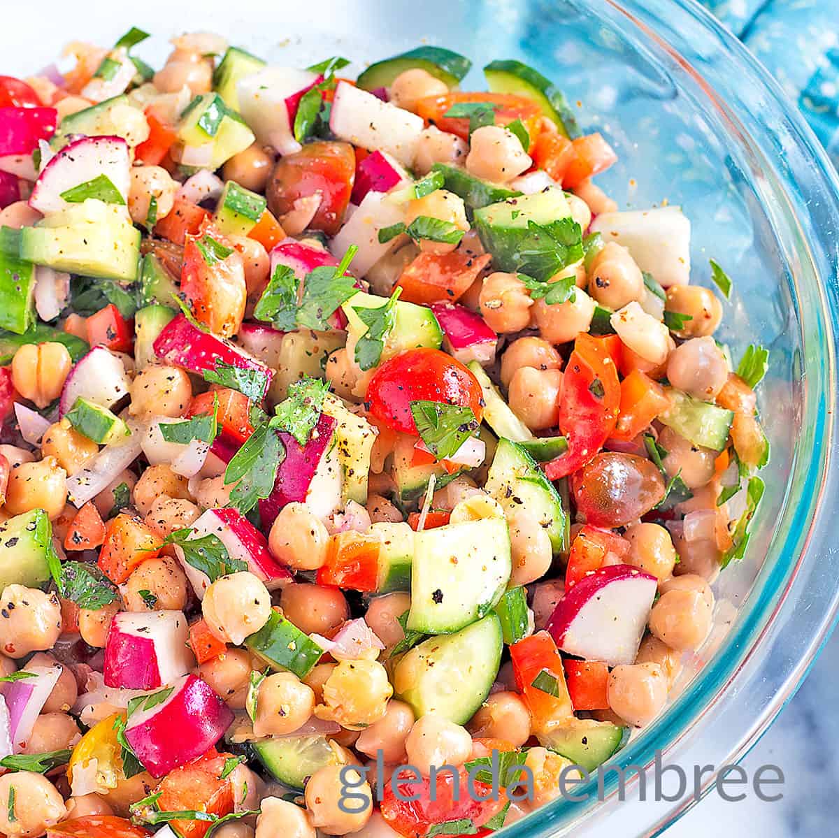 Best Easy Chickpea Salad in a clear glass serving bowl.