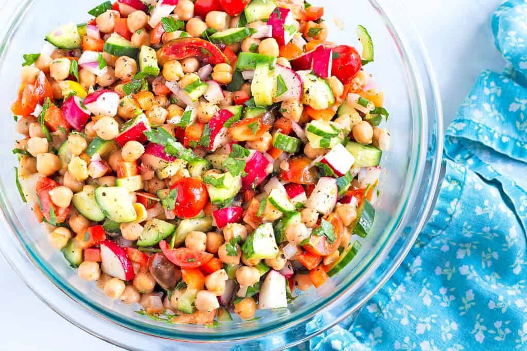 Best Easy Chickpea Salad in a clear glass serving bowl.