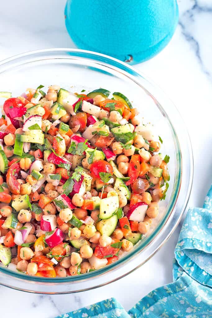 Best Easy Chickpea Salad in a clear glass serving bowl.