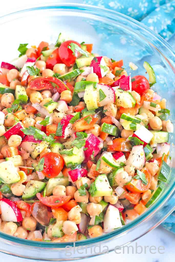 Best Easy Chickpea Salad in a clear glass serving bowl.