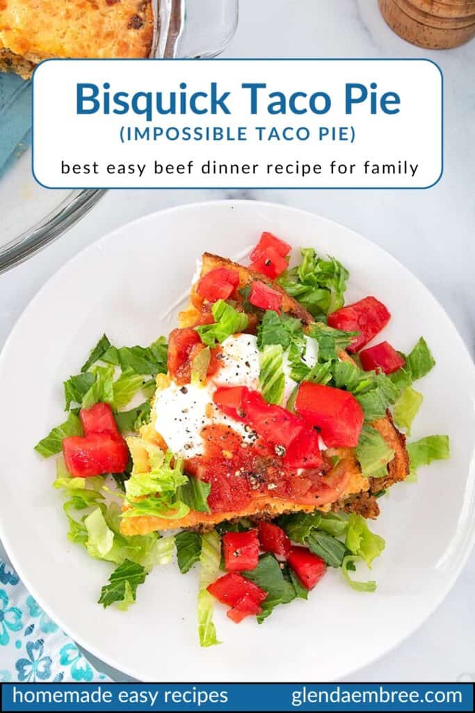 Impossible Taco Pie (Bisquick Taco Pie) topped with sour cream lettuce and tomatoes on a white plate.