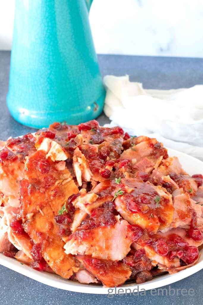 Cranberry Glazed Ham on a white platter.