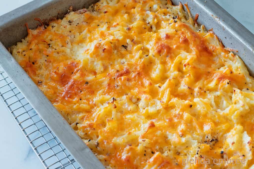 A baked Hashbrown Casserole in a metal 9x13 pan.