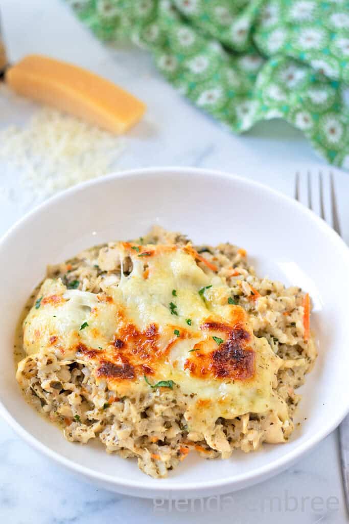 Pesto Alfredo Chicken and Rice served in a white ceramic low-side bowl.