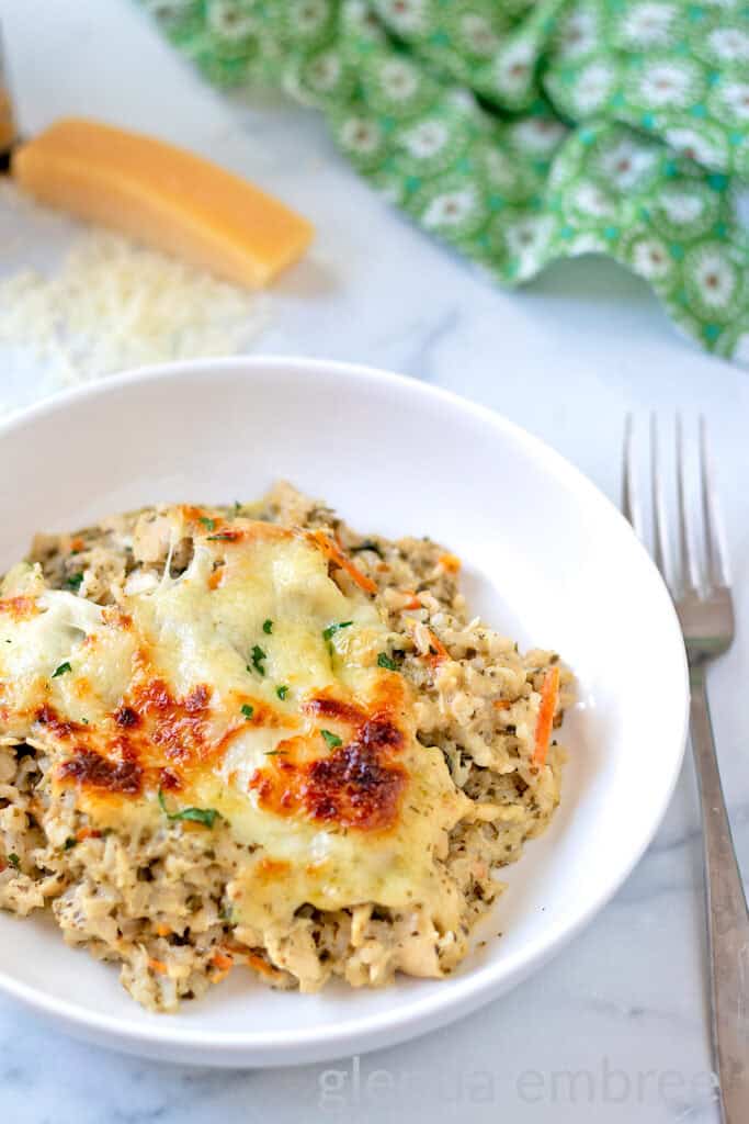 Pesto Alfredo Chicken and Rice served in a white ceramic low-side bowl.