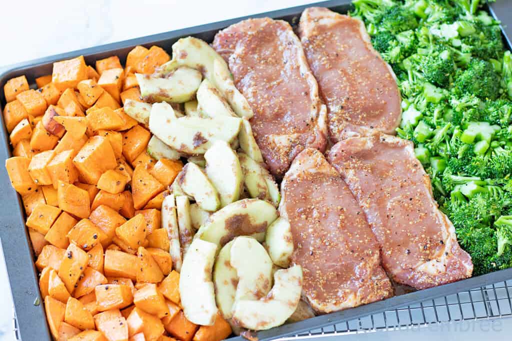 Ingredients for Honey Mustard Pork Chops on a sheet tray ready to be baked.