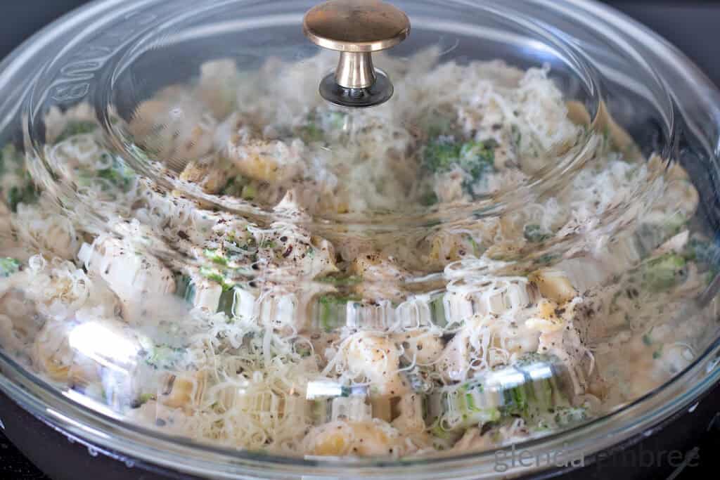 Chicken Tortellini Bake in a covered cast iron skillet.