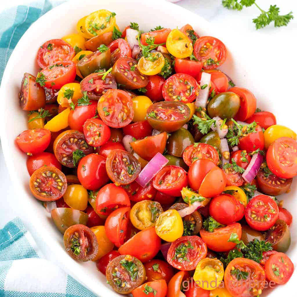 Easy Tomato Salad in a white oval serving bowl.