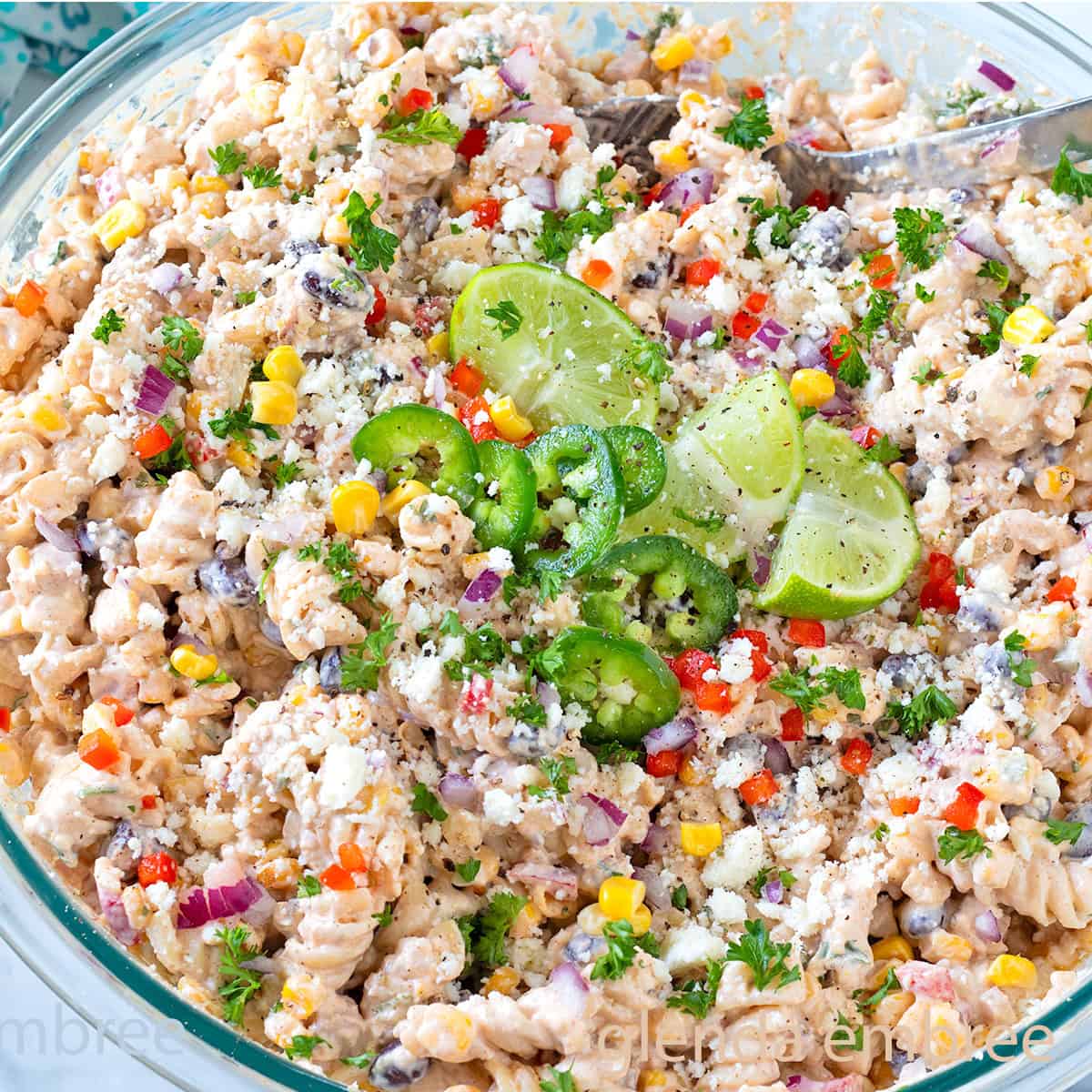 Street Corn Pasta Salad in a clear glass mixing bowl.