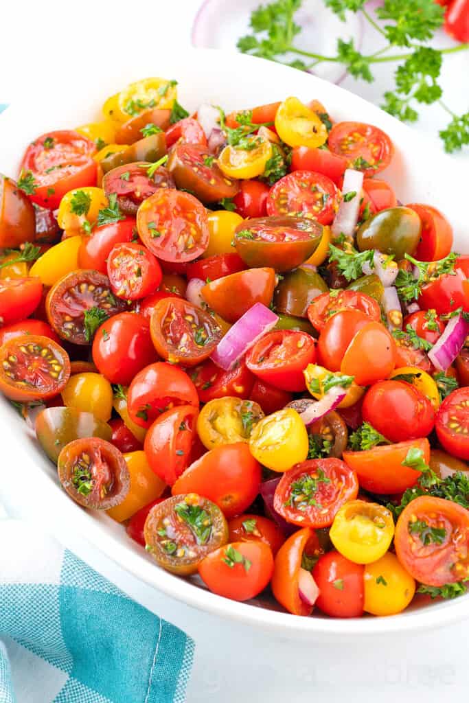 Easy Tomato Salad in a white oval serving bowl.