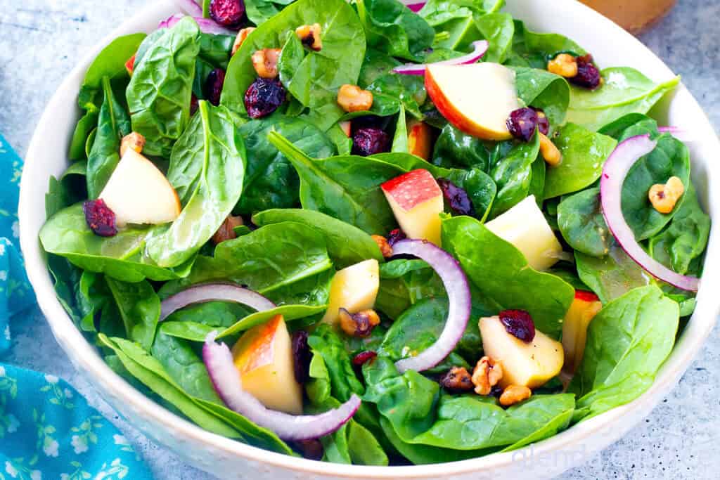 Easy Spinach Salad in a cream colored stoneware bowl.