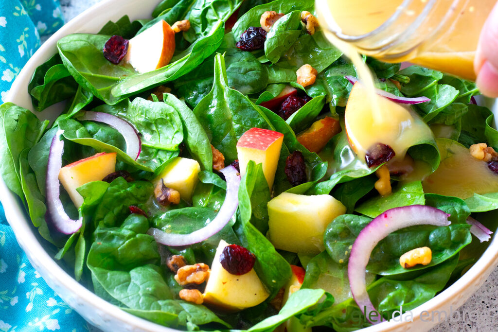 Easy Spinach Salad in a cream colored stoneware bowl.