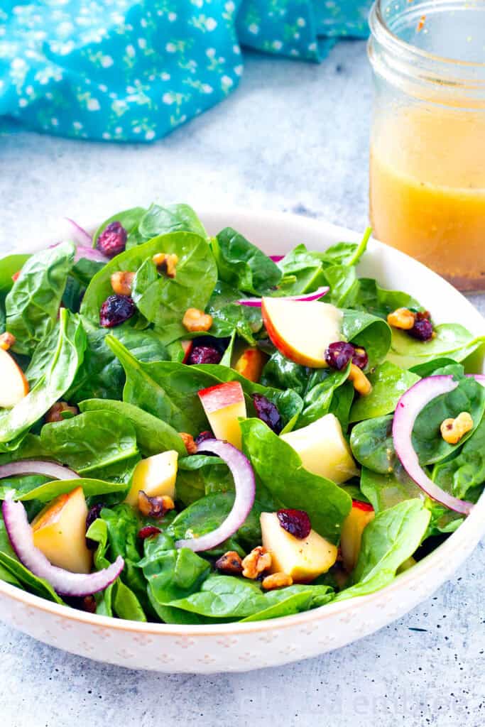 Easy Spinach Salad in a cream colored stoneware bowl.