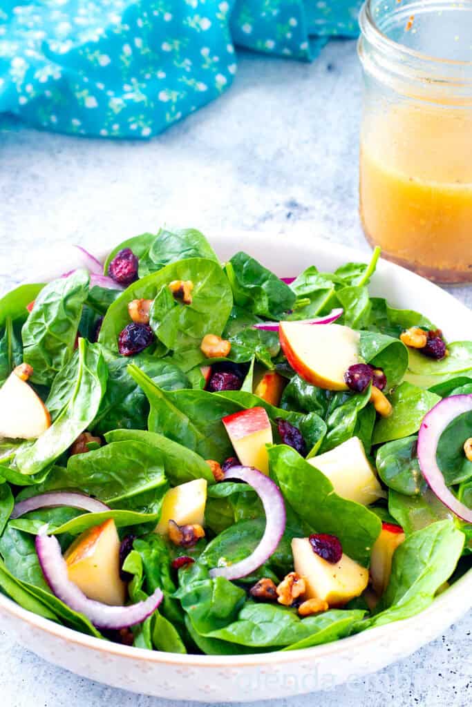 Easy Spinach Salad in a cream colored stoneware bowl.
