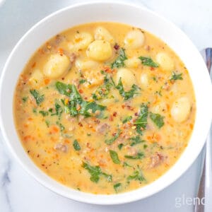 Sausage and Gnocchi Soup in a white ceramic bowl.