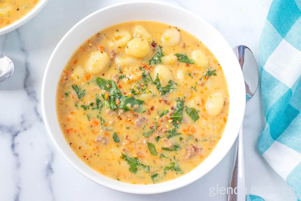 Sausage and Gnocchi Soup in a white ceramic bowl.
