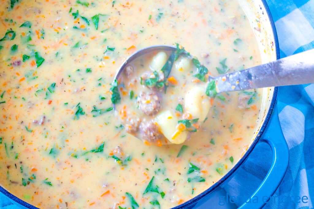 Sausage and Gnocchi Soup in a soup pot with a ladle.