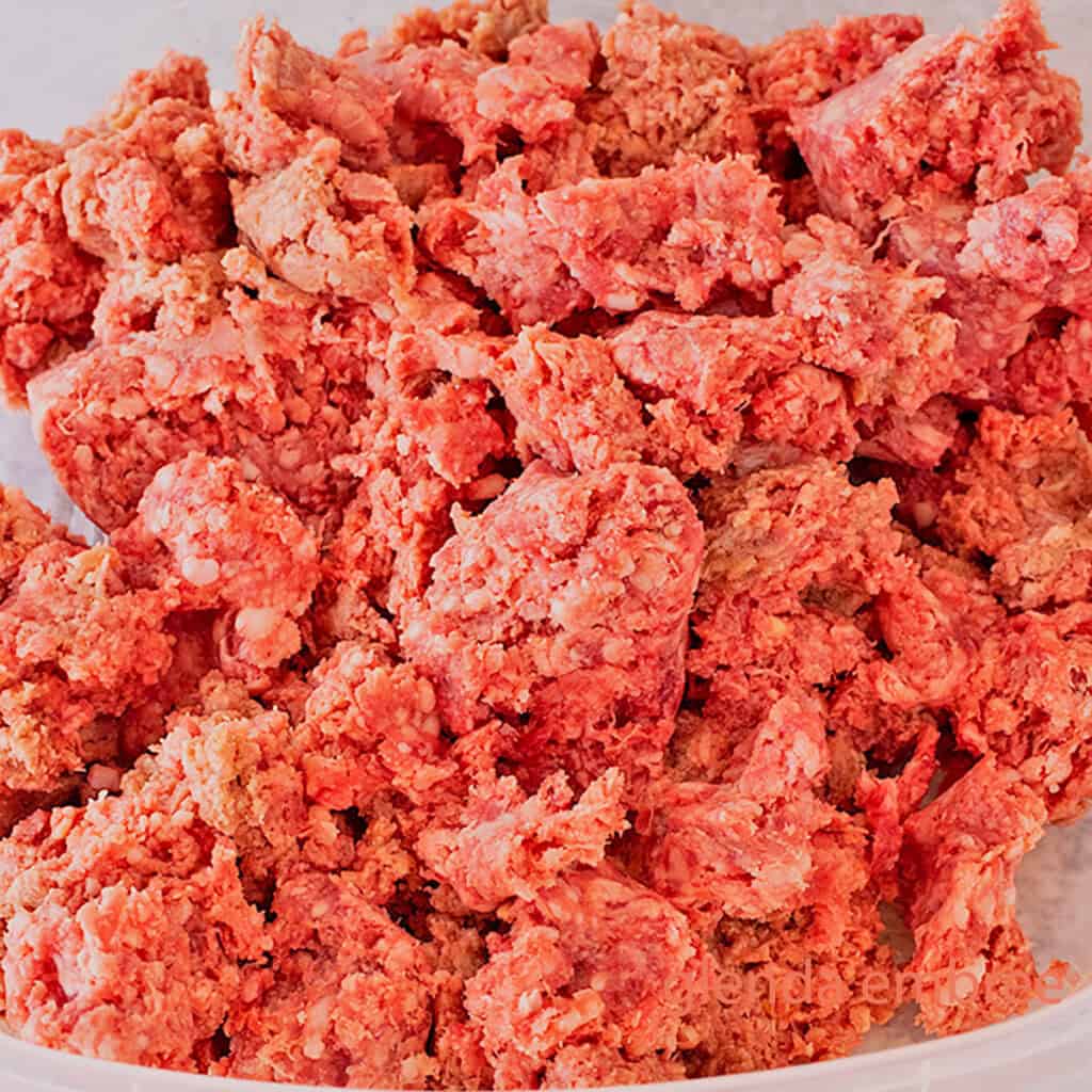 Raw ground beef in a bowl on the counter.