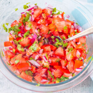 Homemade Pico de Gallo in a clear glass bowl.