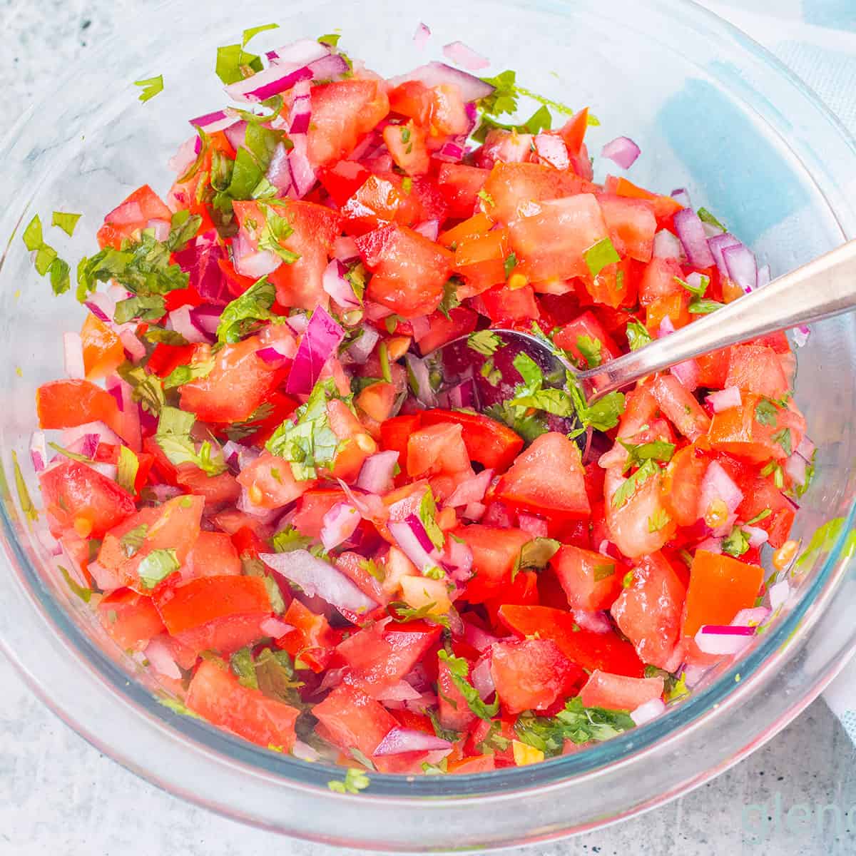 Homemade Pico de Gallo in a clear glass bowl.