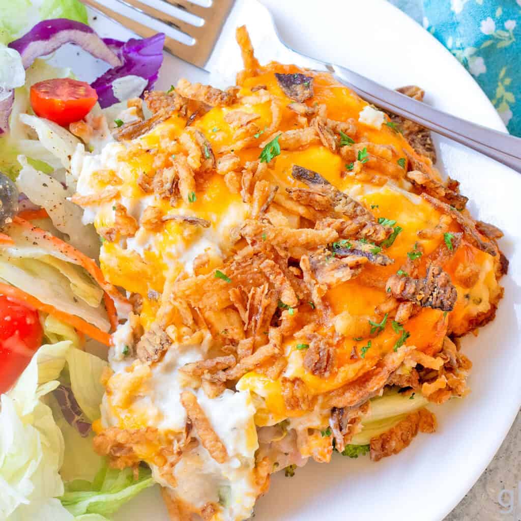 Chicken Casserole (Chicken Broccoli Cheese Casserole) on a white plate with House Salad.