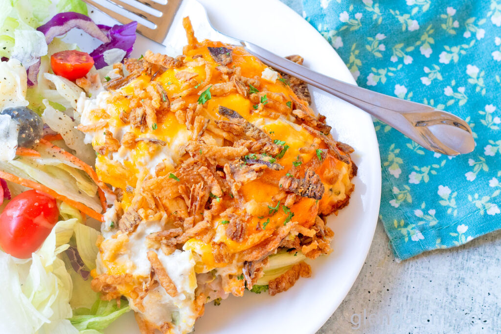 Chicken Casserole (Chicken Broccoli Cheese Casserole) on a white plate with House Salad.