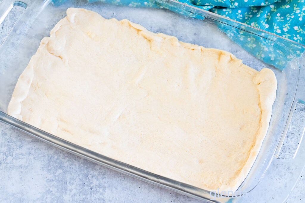 Crescent dough pressed into the bottom of a 9x13 baking pan as the crust for chicken casserole.