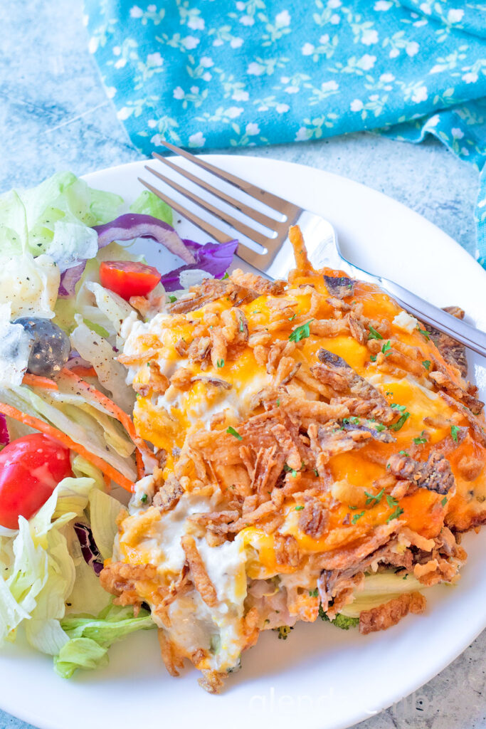 Chicken Casserole (Chicken Broccoli Cheese Casserole) on a white plate with House Salad.