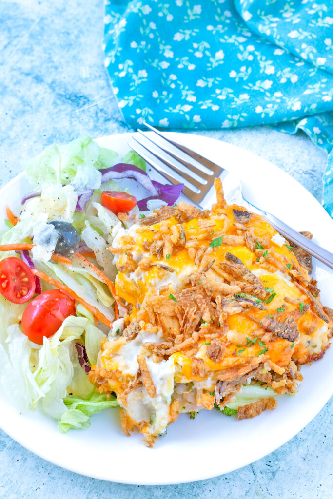 Chicken Casserole (Chicken Broccoli Cheese Casserole) on a white plate with House Salad.